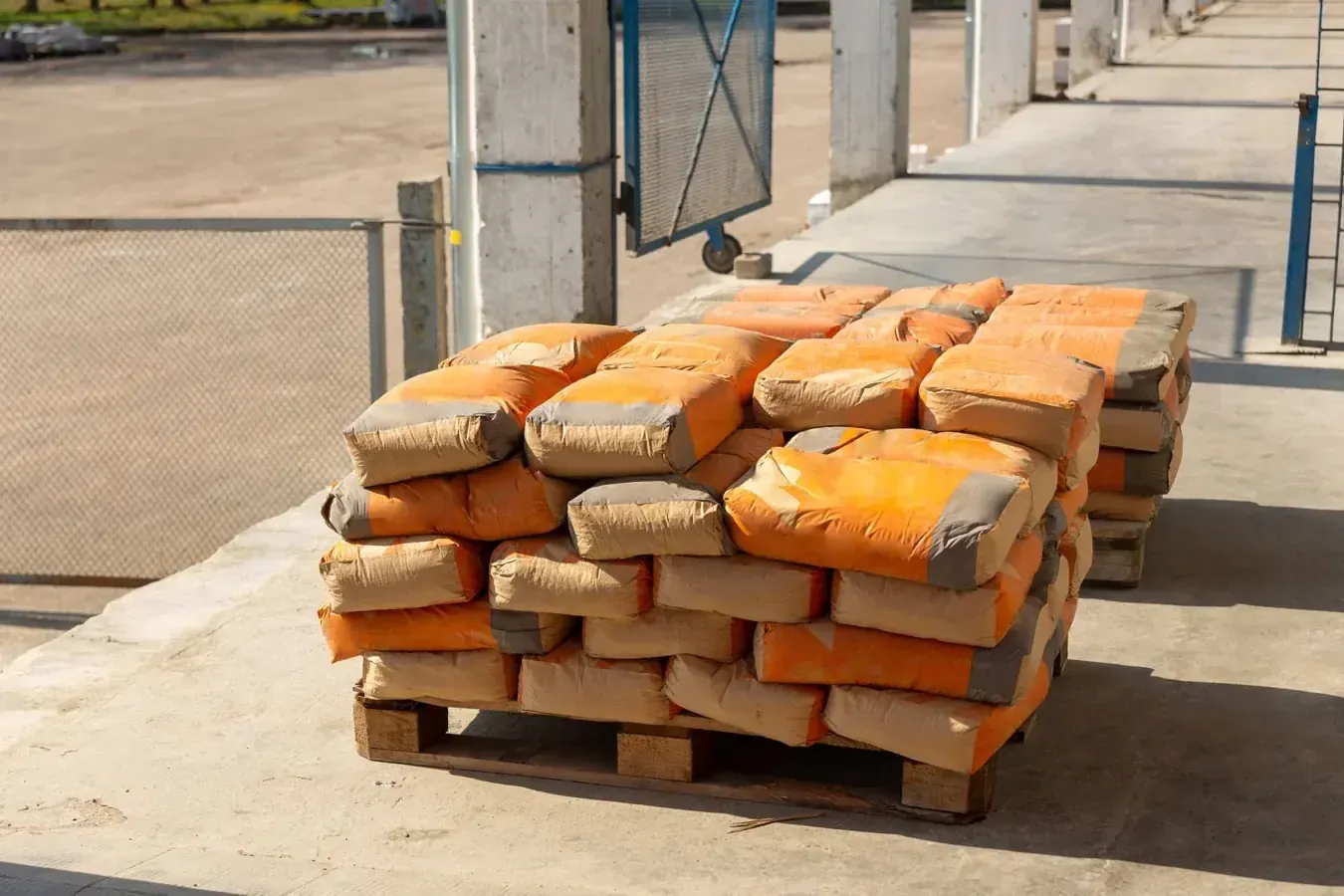 Stack of UltraTech PPC Cement 50kg bags at a Bengaluru construction site